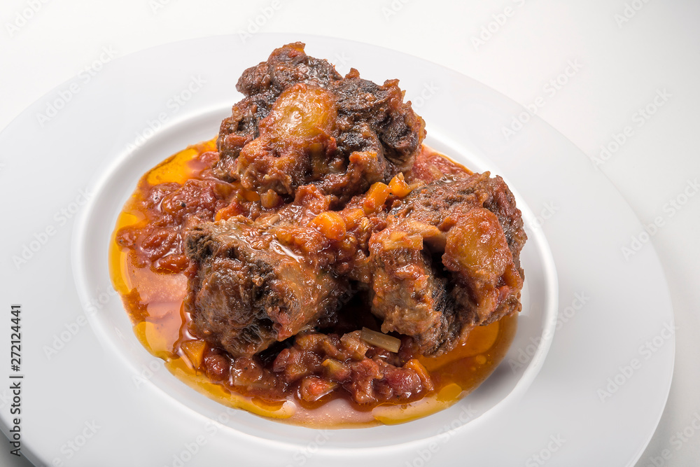 Isolated Dish with a portion of oxtail stewed vaccinara