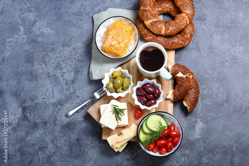 Traditional turkish breakfast with olives, simit bagels, feta cheese, coffee, honey combs, oriental snack