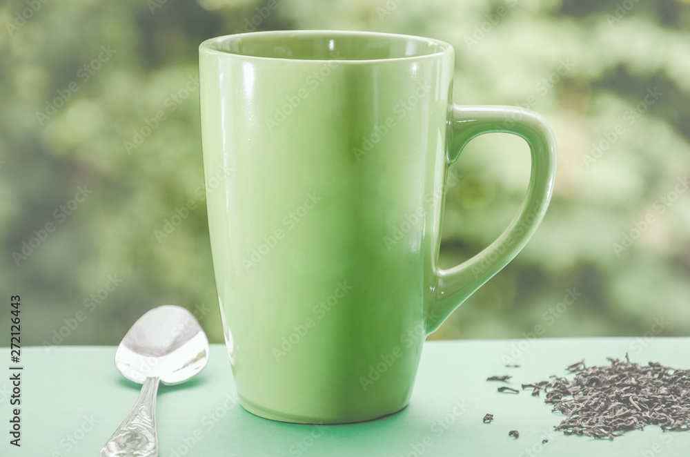 green cup of tea on a beautiful green background. Tinted. green cup of tea on a beautiful green background. Tinted.