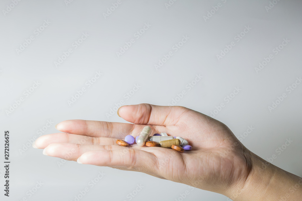 Tablets and capsules on the palm of the doctor And close-up photography on a white background Tablets and capsules on the palm of the doctor And close-up photography on a white background
