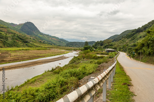 asphalt mountain road along the river, Dien Bien province, Vietnam