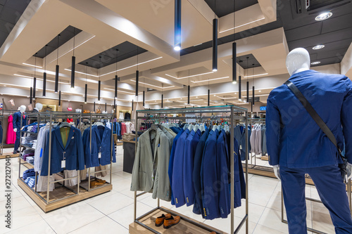 Internal view of a fashion store with generic jackets, mannequins, jeans and clothes.