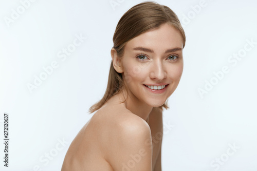 Beauty. Woman model with fresh skin and white smile portrait