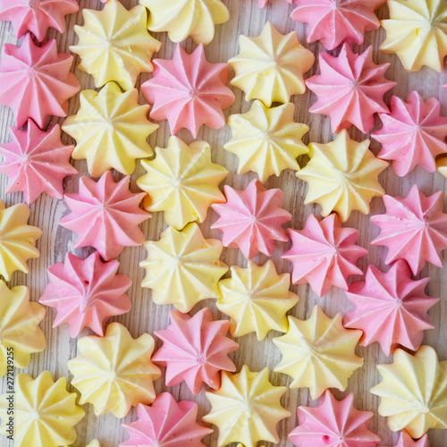 Mini meringues on a white wooden surface  top view. Flat lay  from above  overhead.