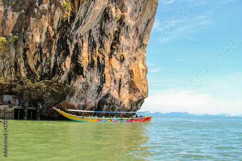 Tourist boat parking on rocks in Thailand