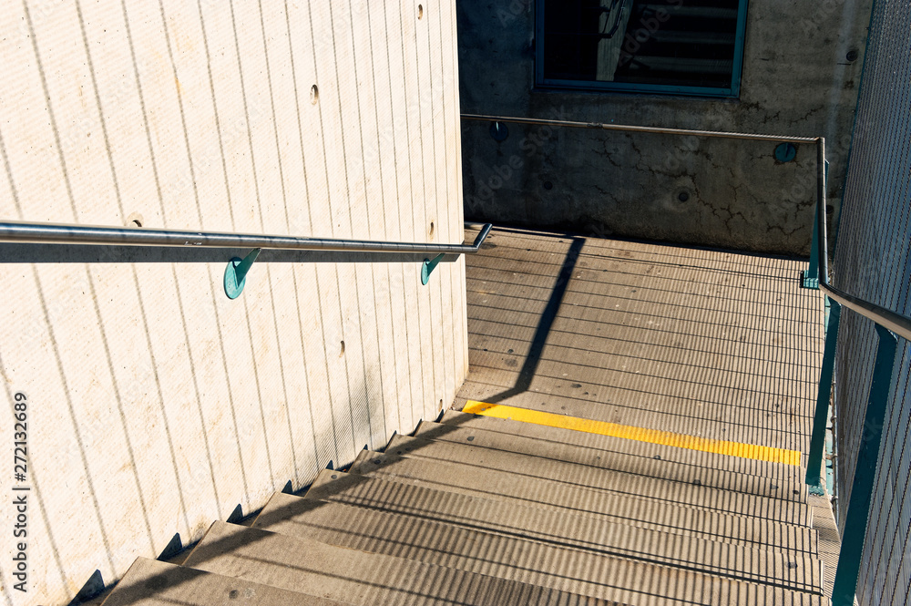 Obraz premium Staircase in a public overpass with concrete and steel and bars
