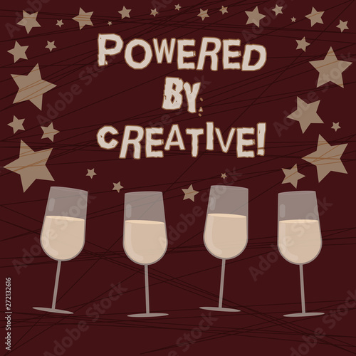 Conceptual hand writing showing Powered By Creative. Business photo showcasing characterized by originality of thought or inventiveness Filled Cocktail Wine with Scattered Stars Confetti Stemware