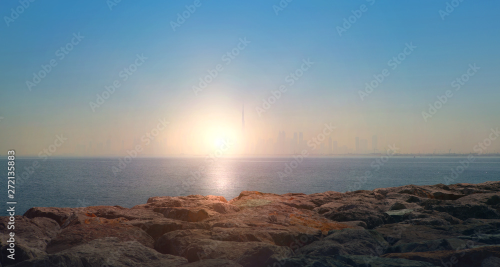 Sunset in the Persia Gulf and Burj Khalifa at distant. Dubai, United Arab Emirates. UAE