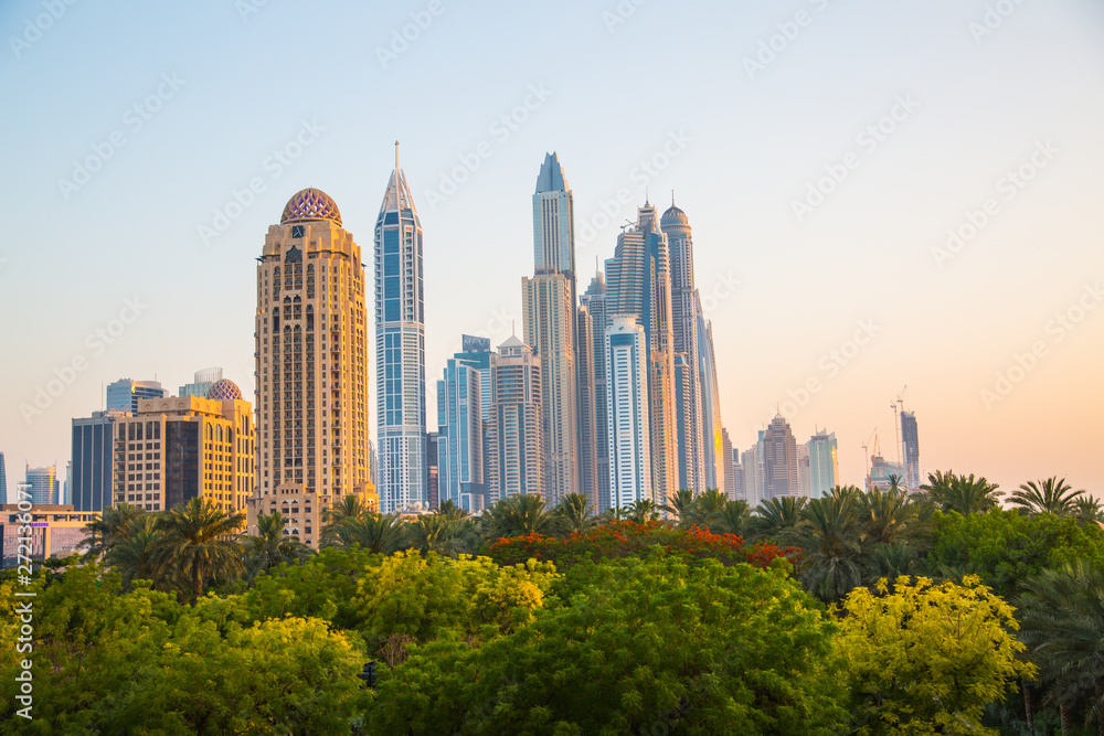 Dubai marina skyline at sunset. Dubai Marina is a district with lots of hotels, restaurants, residential apartments and entreatments  in Dubai United Arab Emirates.