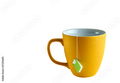 Yellow cup with tea pack on white background