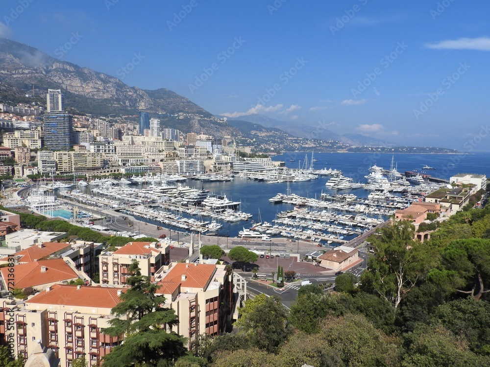 Panoramic view of harbor with boats and skyline of Monaco on sunny summer day, French Riviera, Monaco .