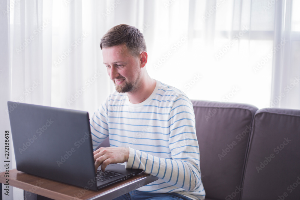 man working on his laptop at home man working on his laptop at home
