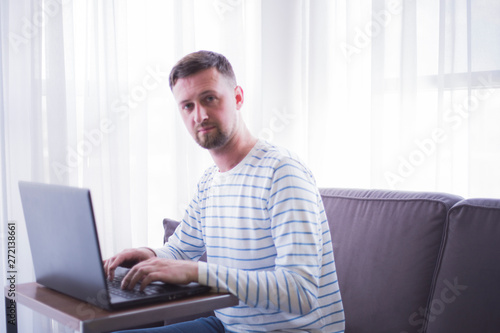 man working on his laptop at home © kristinav85