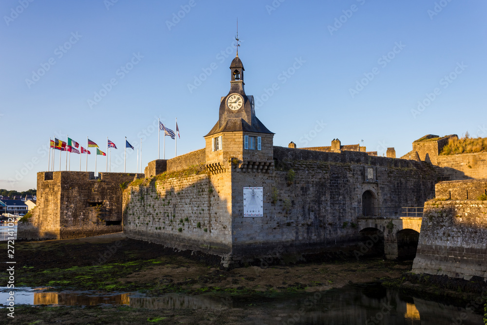 Walled town of Concarneau at sunset and low tide, Brittany, France 