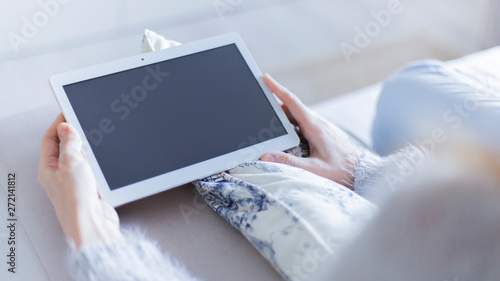woman using digital tablet in bed