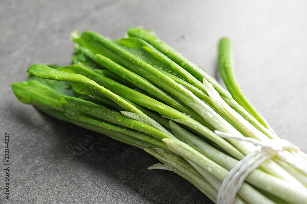 Obraz premium Bunch of wild garlic or ramson on grey table, closeup