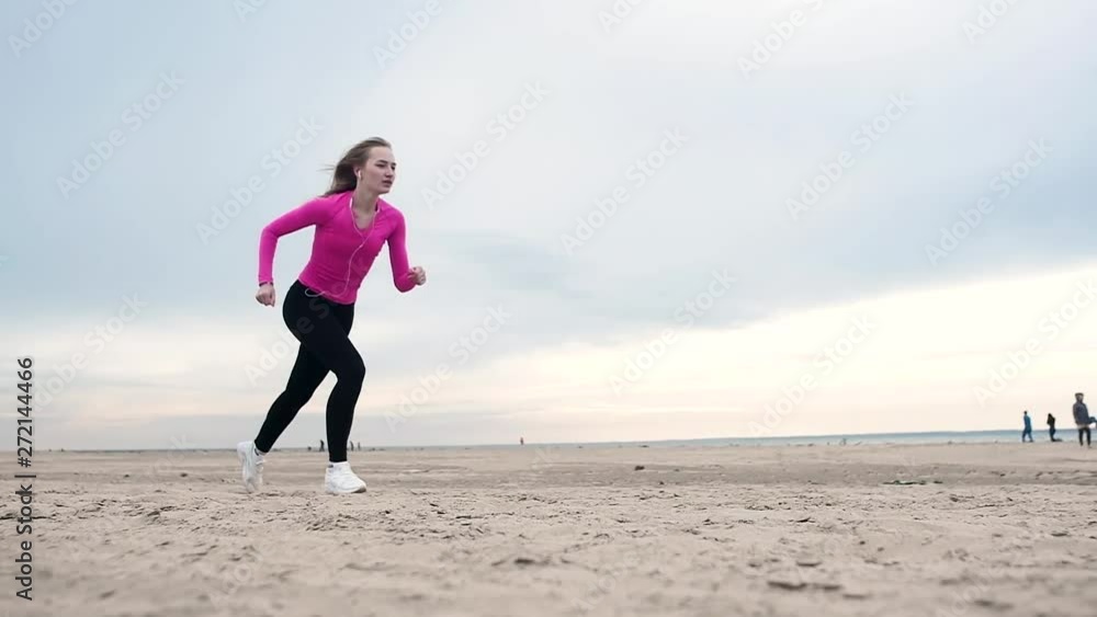 beautiful girl running on the beach against the sea coast. Fitness training. beautiful girl running on the beach against the sea coast. Fitness training.
