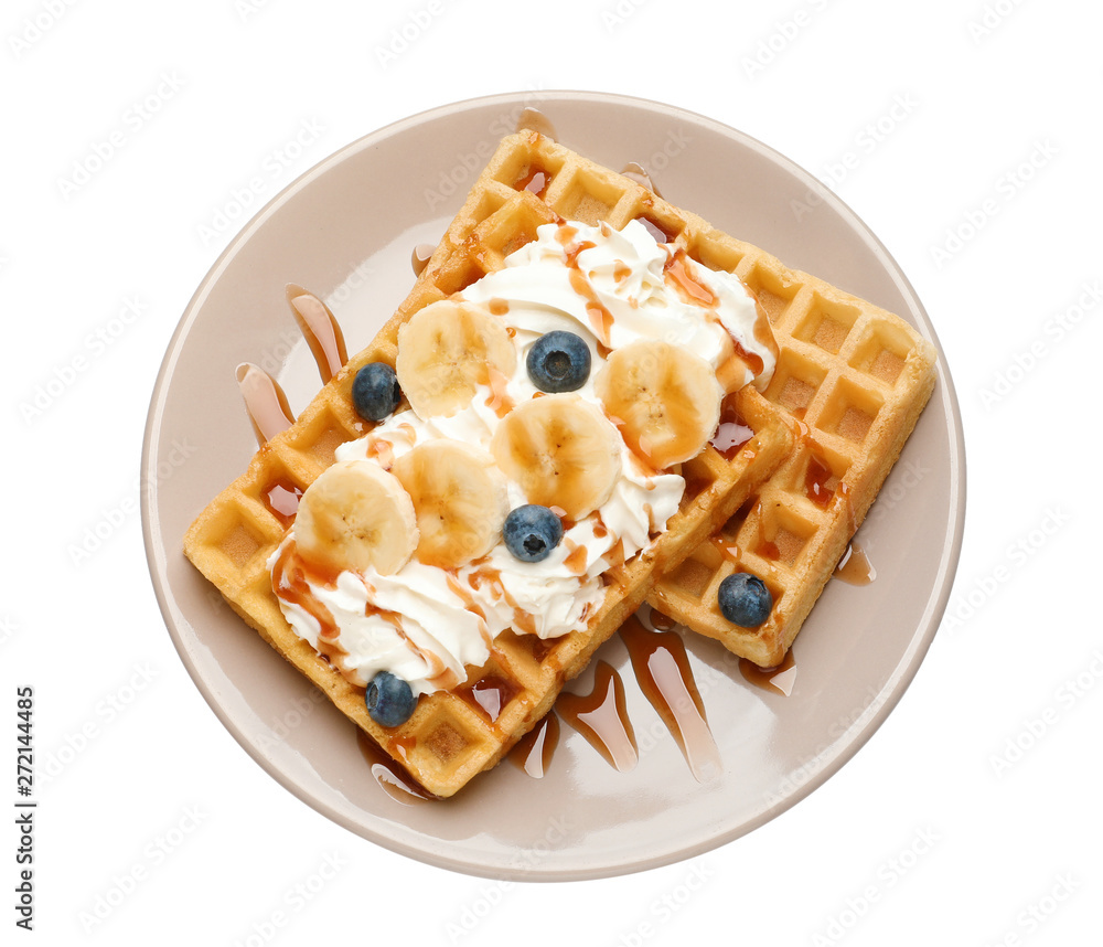 Plate with yummy waffles, whipped cream, blueberries and banana on white background, top view Plate with yummy waffles, whipped cream, blueberries and banana on white background, top view