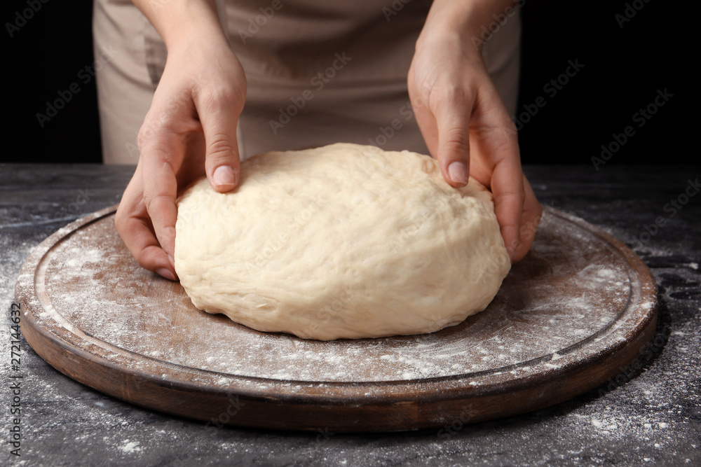 Female baker preparing bread dough at table, closeup Female baker preparing bread dough at table, closeup