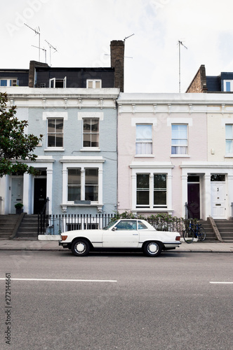 Photography Street in West London with typical Victorian houses and vintage car