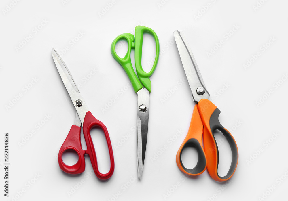 Set of different scissors on white background, top view