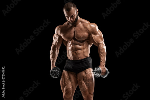 Bodybuilder man isolated on the black background. Strong male naked torso abs