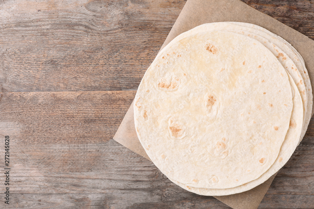 Corn tortillas on wooden background, top view with space for text. Unleavened bread Corn tortillas on wooden background, top view with space for text. Unleavened bread