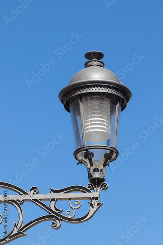 Closeup of vintage modern metal street lantern or lamp against blue sky in Torremolinos, spain, andalusia. Macro.