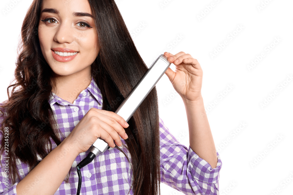Happy woman using hair iron on white background Happy woman using hair iron on white background