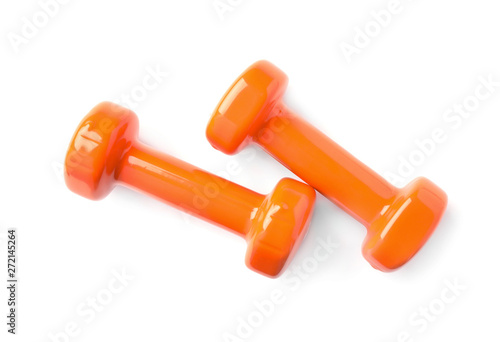 Color dumbbells on white background. Home fitness, top view