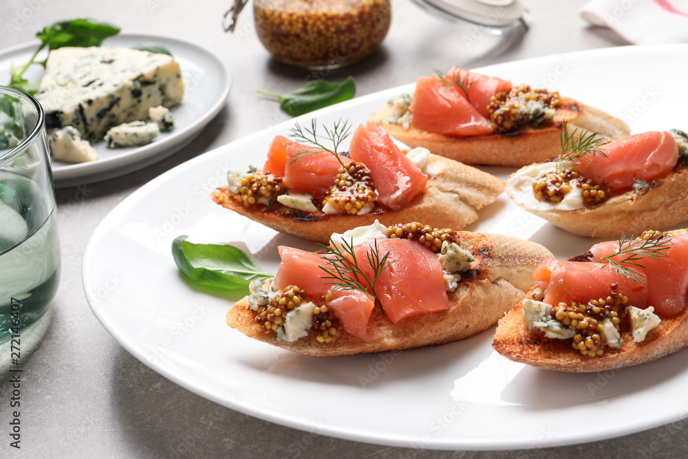 Tasty bruschettas with salmon and blue cheese served on table Tasty bruschettas with salmon and blue cheese served on table