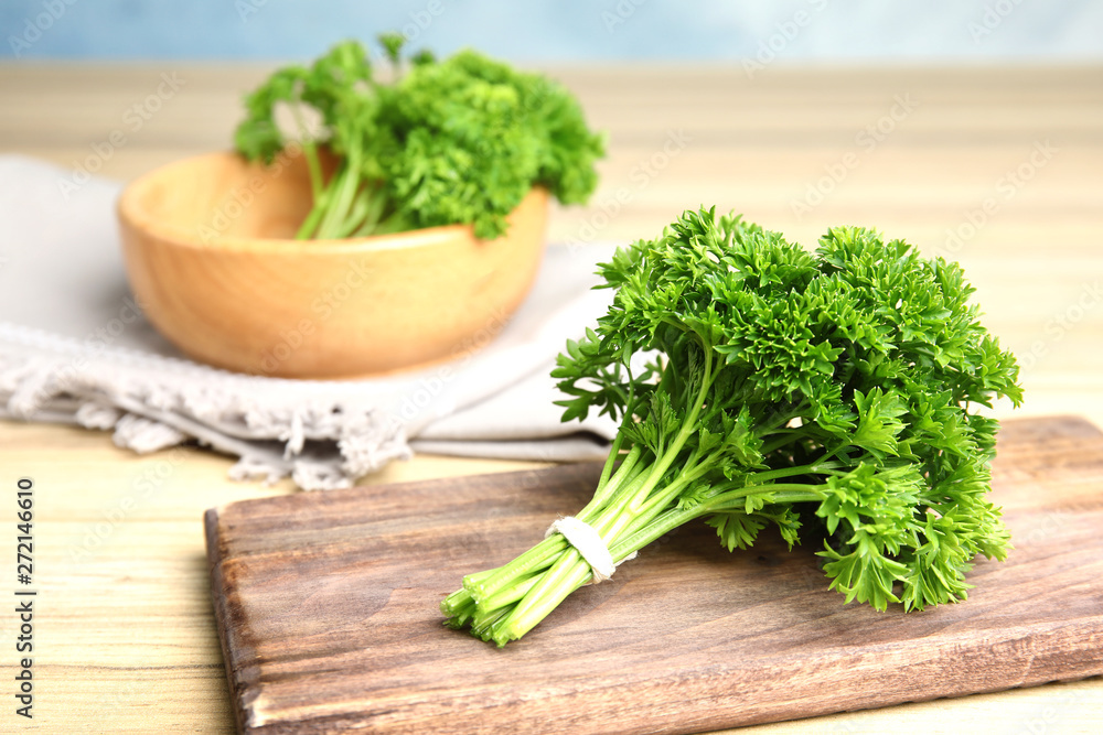 Fresh green parsley on wooden table, space for text