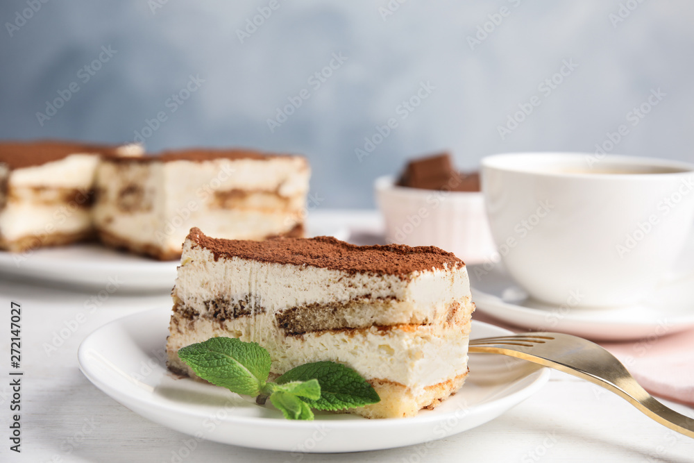 Tiramisu cake and drink served on table Tiramisu cake and drink served on table