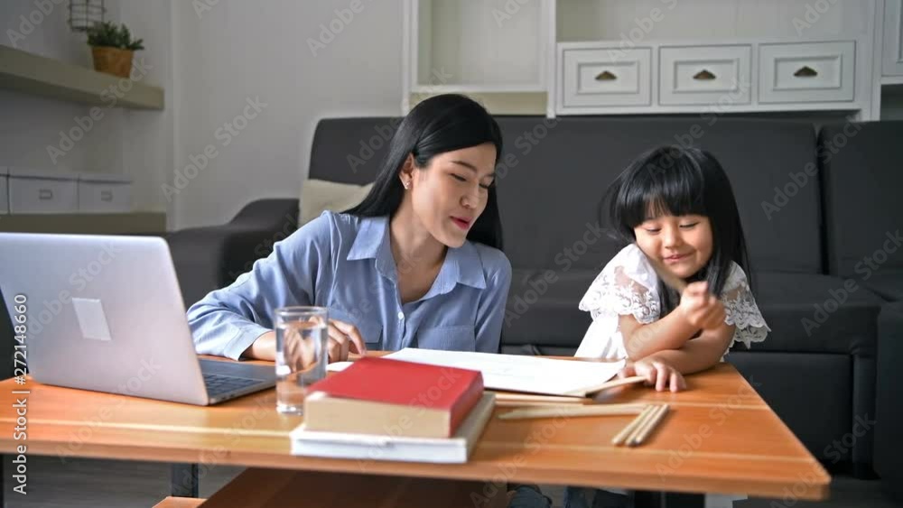 Family concept. Mother is teaching daughter to paint in the living room. Family concept. Mother is teaching daughter to paint in the living room.