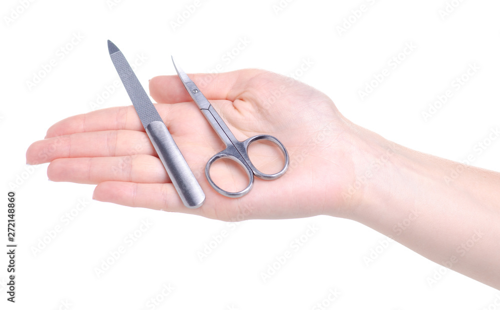 Manicure nail file and scissors in hand on white background isolation Manicure nail file and scissors in hand on white background isolation