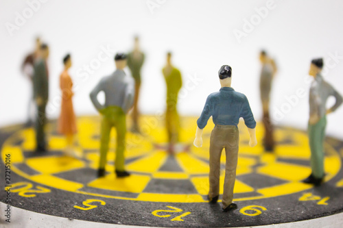 Miniature businesspeople stand on dartboard. business competition concept.