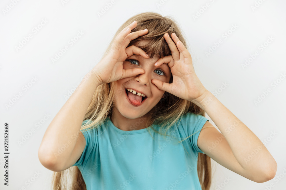 Making face,funny foolishes portrait of 9 year girl, against white background. Making face,funny foolishes portrait of 9 year girl, against white background.