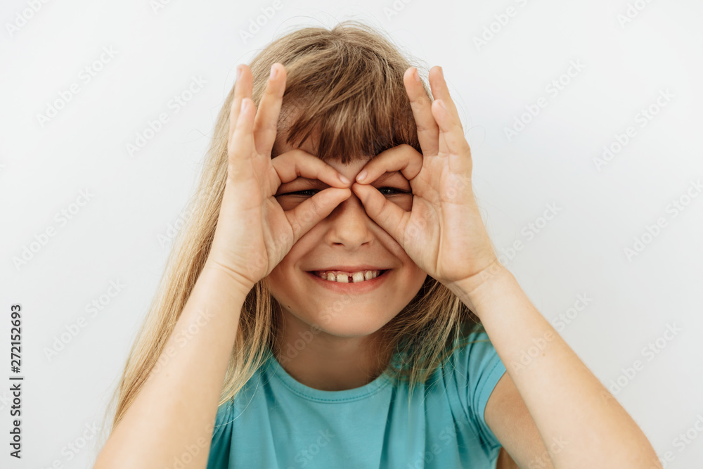 Making face,funny foolishes portrait of 9 year girl, against white background. Making face,funny foolishes portrait of 9 year girl, against white background.
