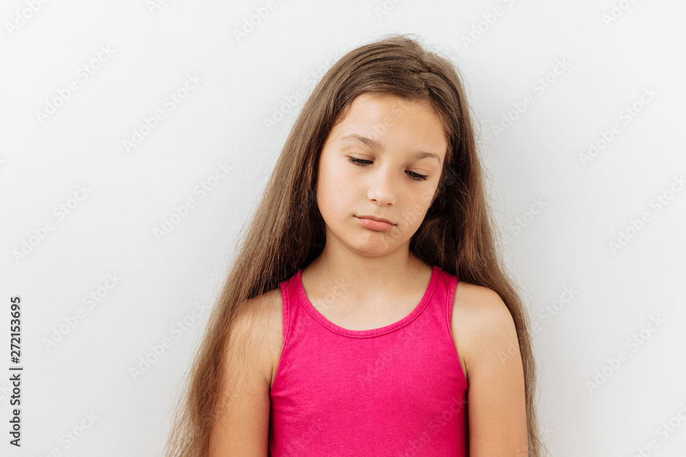 Sad,Tired,boredom and exhausted emotion 9 year girl portrait against white background Sad,Tired,boredom and exhausted emotion 9 year girl portrait against white background