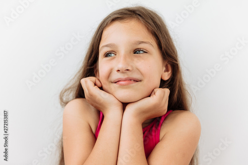 Dreamy,pleased, thinking emotion . Wish concept. 9 year girl face portrait on white backgound.