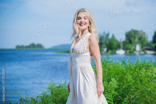 Nice blonde lady at nature. Woman in flying silk white dress at outdoor, relax time  © T.Den_Team