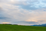 countryside landscape under blue sky and dramatic white clouds
