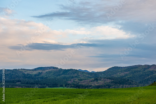 countryside landscape under blue sky and dramatic white clouds