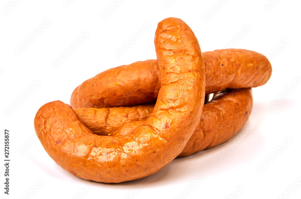 Grilled sausages on a light background. Juicy sausage rings in a pile on a white background. Grilled sausages on a light background. Juicy sausage rings in a pile on a white background.