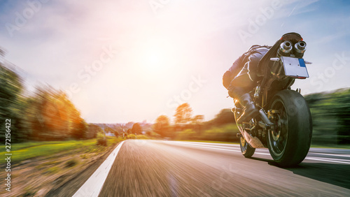 motorbike on the road riding. having fun riding the empty road on a motorcycle tour / journey