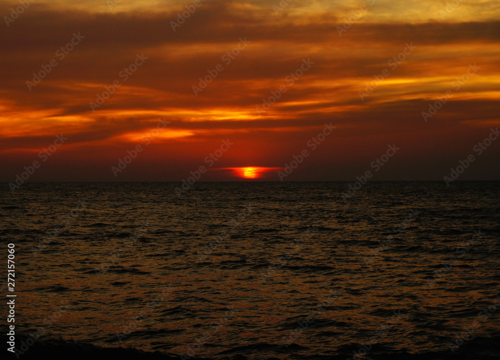 Bright contrast saturated sunset on the ocean on the southern tropical coast. Bright contrast saturated sunset on the ocean on the southern tropical coast.