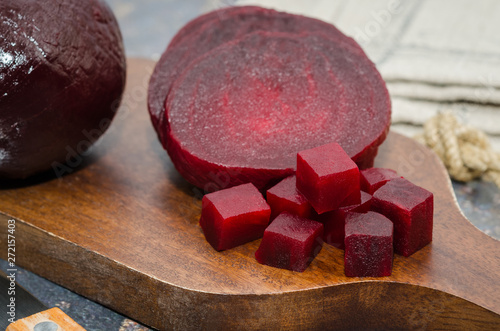 Sliced cooked beetroot on a wooden board