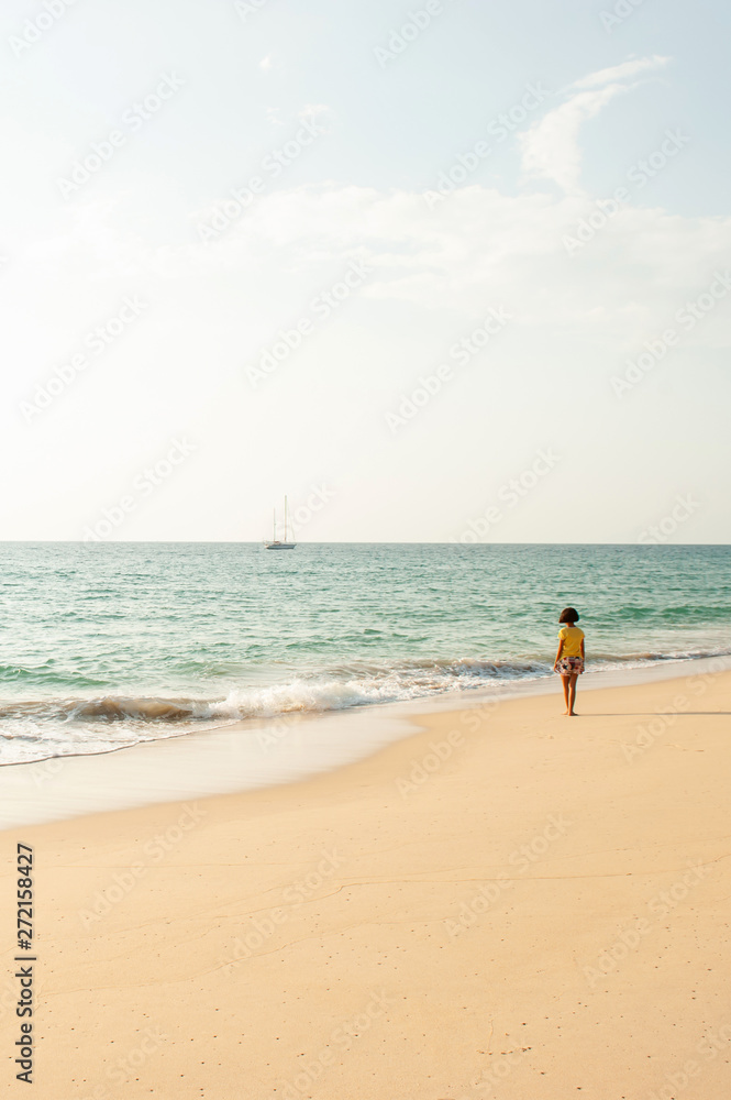 An Asian girl relaxing on the sunset beach.