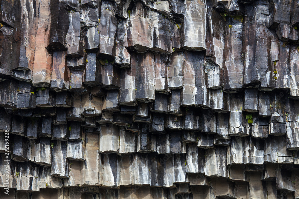 Black basalt columns of Reynisfjara look like huge pencils, a world-famous black-sand beach found on the South Coast of Iceland. Black basalt columns of Reynisfjara look like huge pencils, a world-famous black-sand beach found on the South Coast of Iceland.