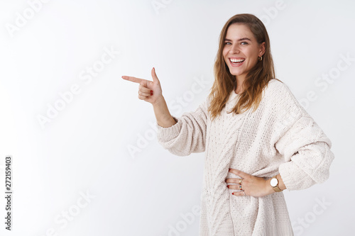Fotografija Girl laughing smiling happily standing profile pointing index fingers side turni